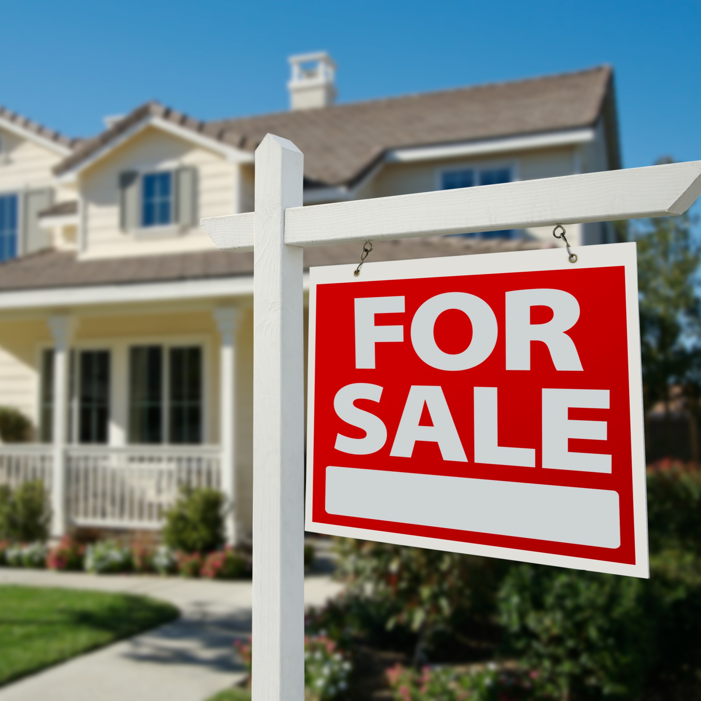 For sale sign in front of house